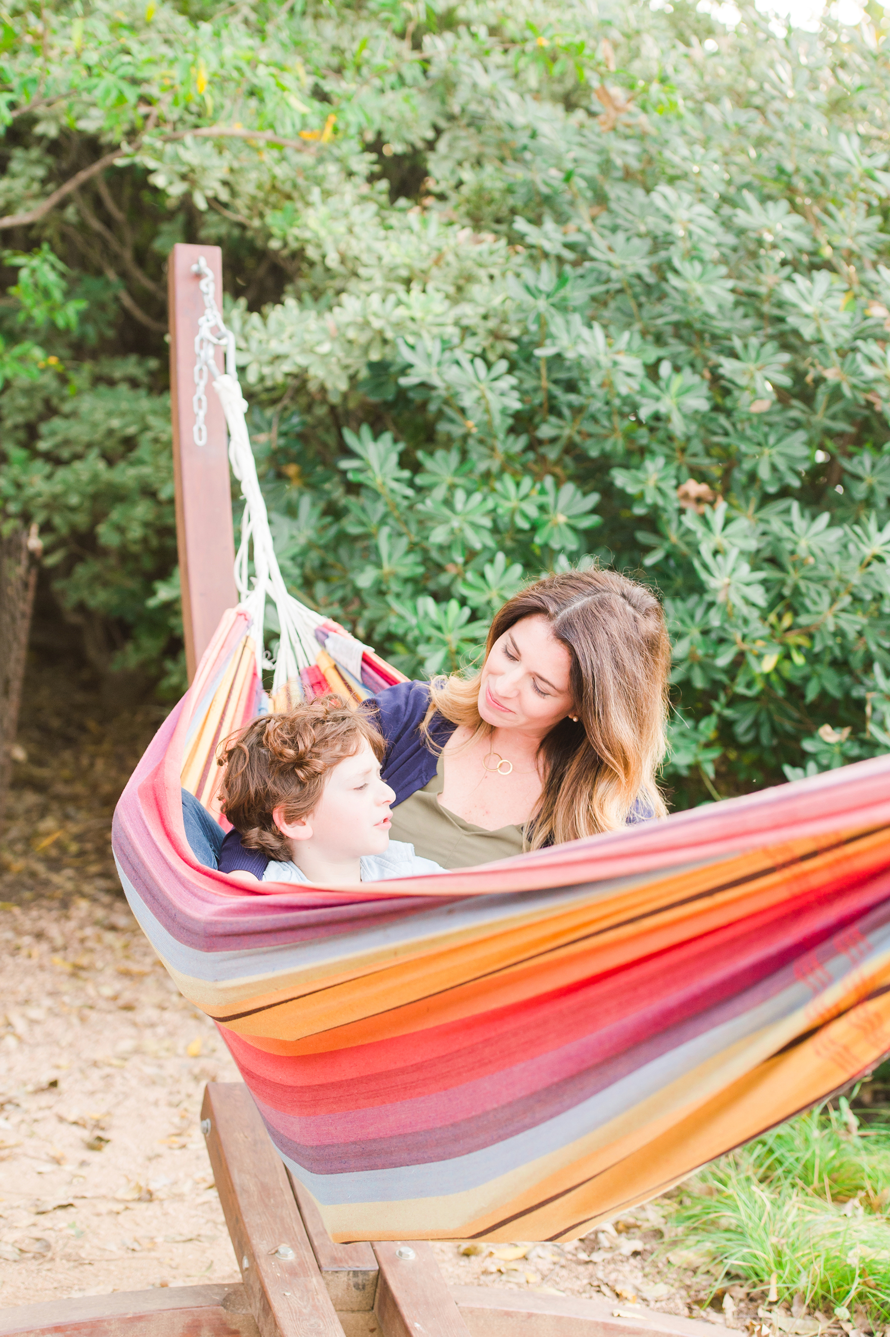 Grant tells mom a story, while they cuddle up in the hammock.