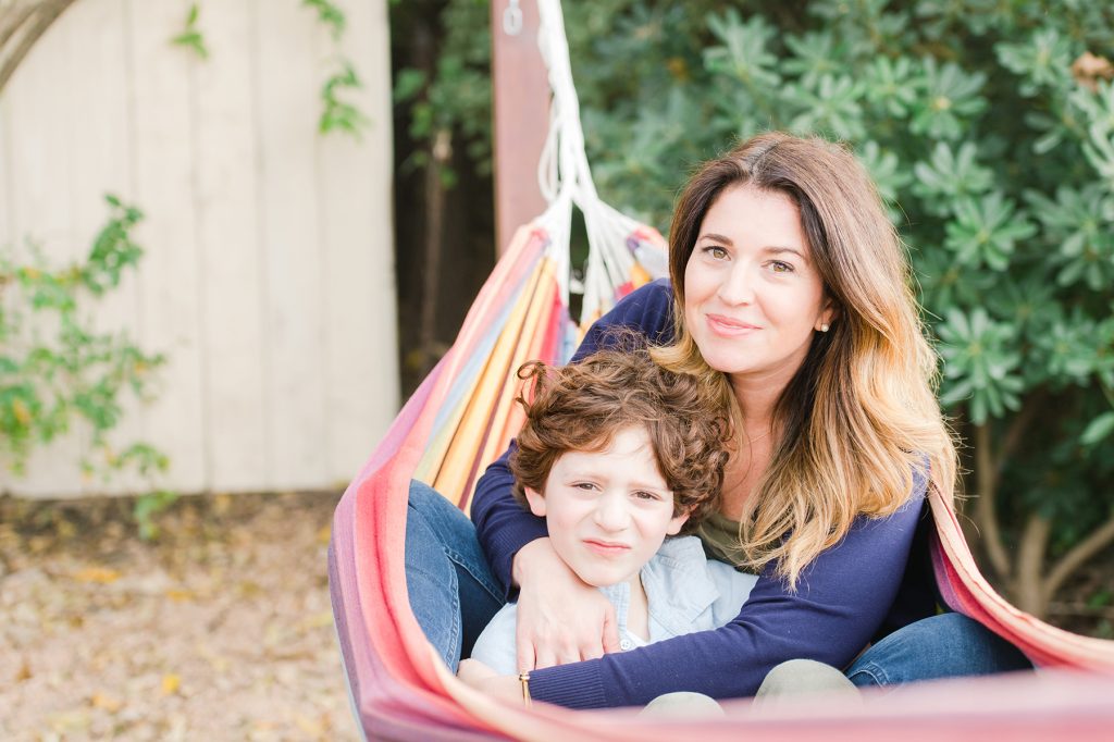 Victoria snuggles her son closely while in the hammock.