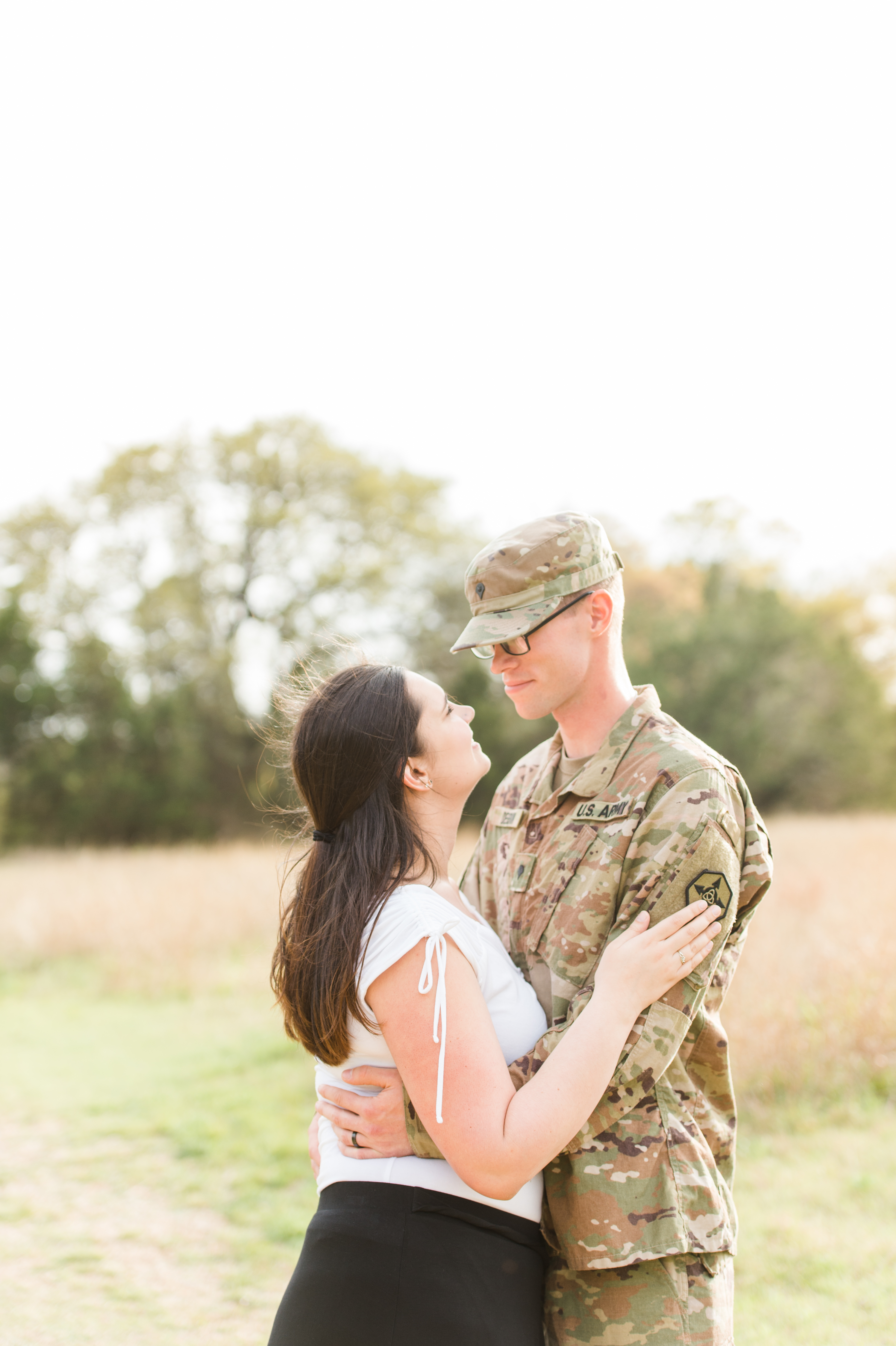 The military couple looks up at each other lovingly.