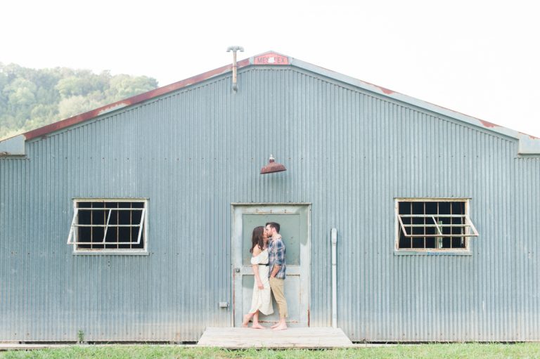 kissing-in-front-blue-shed-rustic-texas-engagement