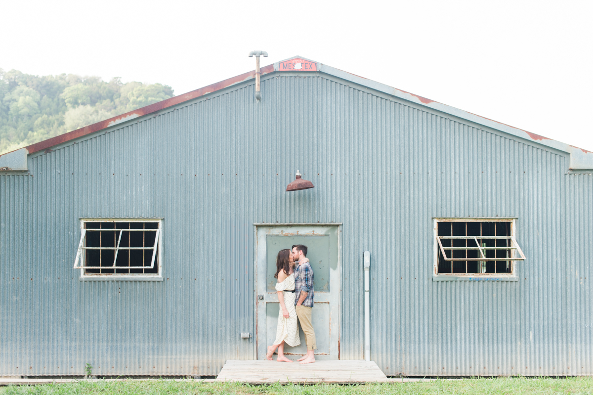 kissing-in-front-blue-shed-rustic-texas-engagement