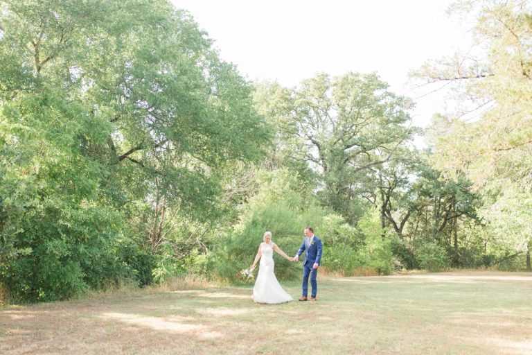 couple-walks-together-field-grass-austin-texas