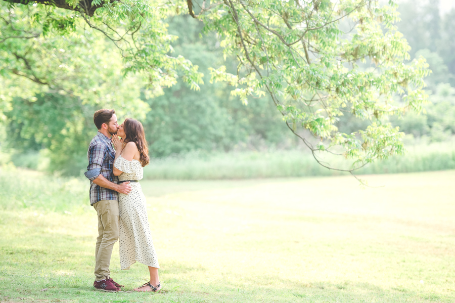engaged-couple-kisses-Austin-hill-country