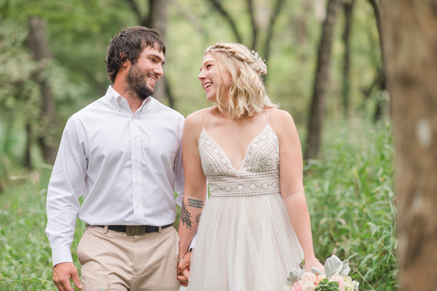 couple-smiles-after-ceremony-greenery-bull-creek-park-wedding