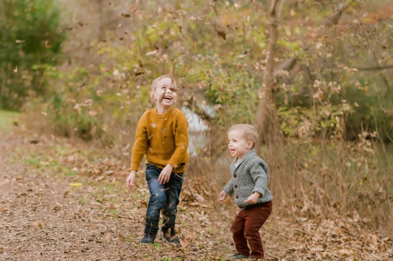 brothers-throw-fall-leaves-into-air-austin-hill-country