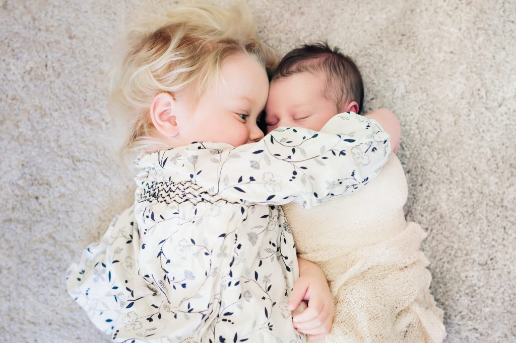 siblings-snuggle-floor-documentary-newborn-photography-austin