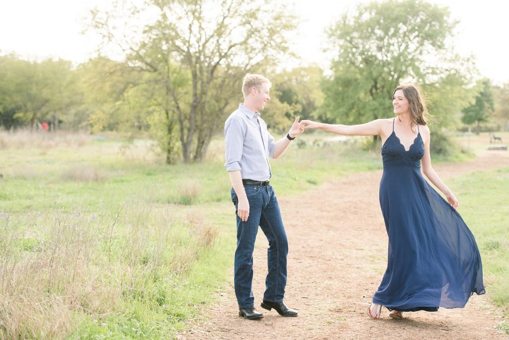 Couple-dances-in-field-for-engagement-photography-Austin