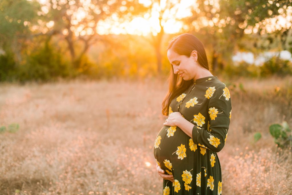 holding-baby-bump-sunset-dripping-springs