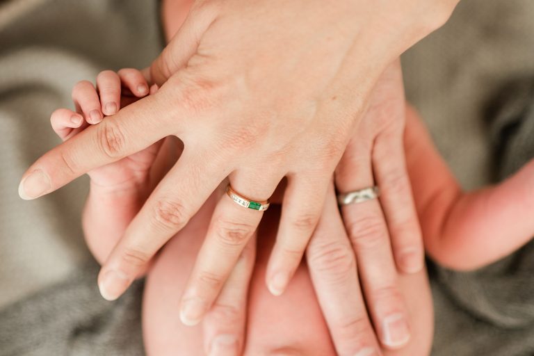 austin-newborn-baby-hand-mothers-hand-wedding-ring