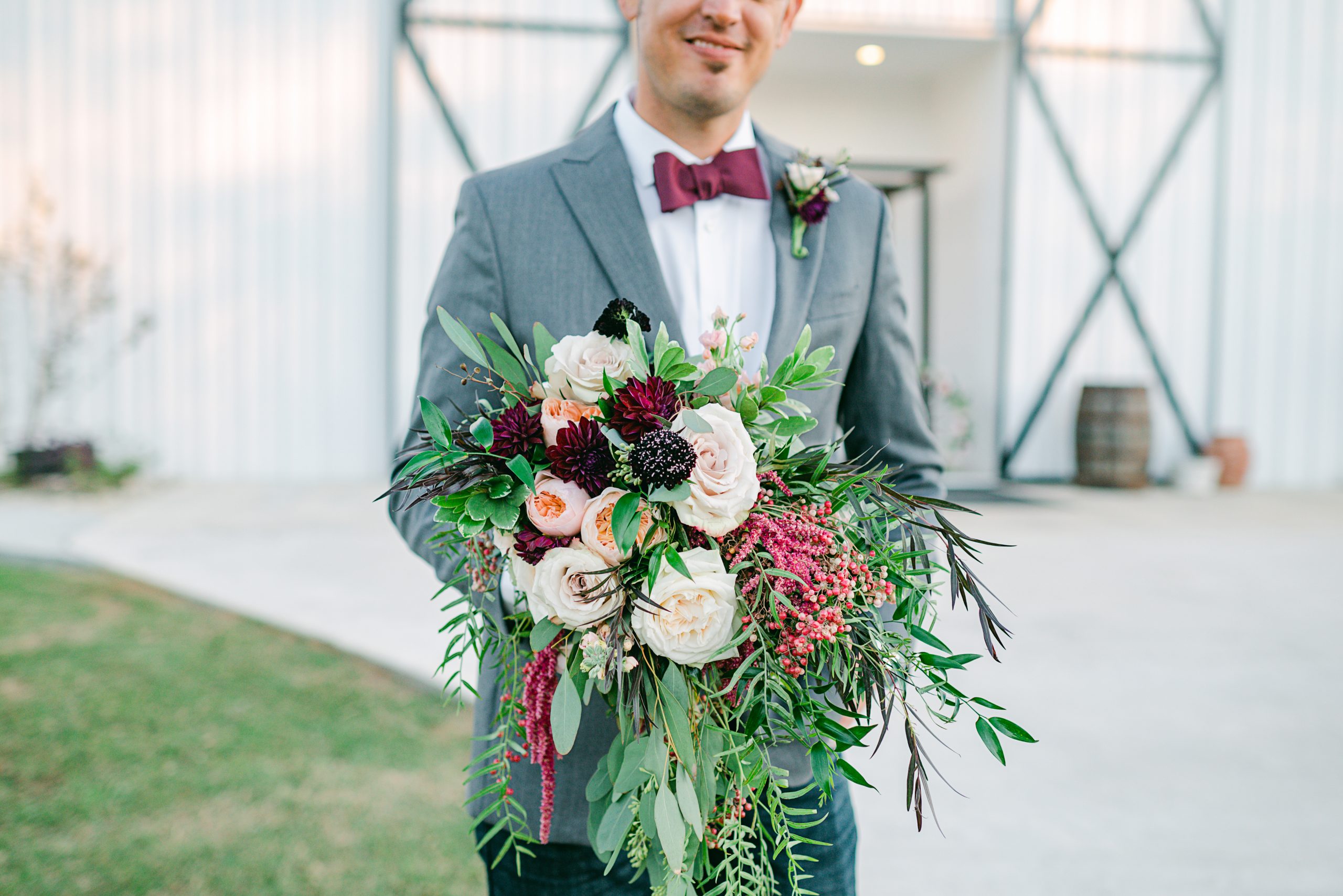 groom-holds-bouquet-austin-texas-wedding-photographer