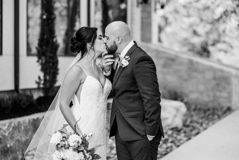 kiss-outside-reception-austin-top-wedding-photographers