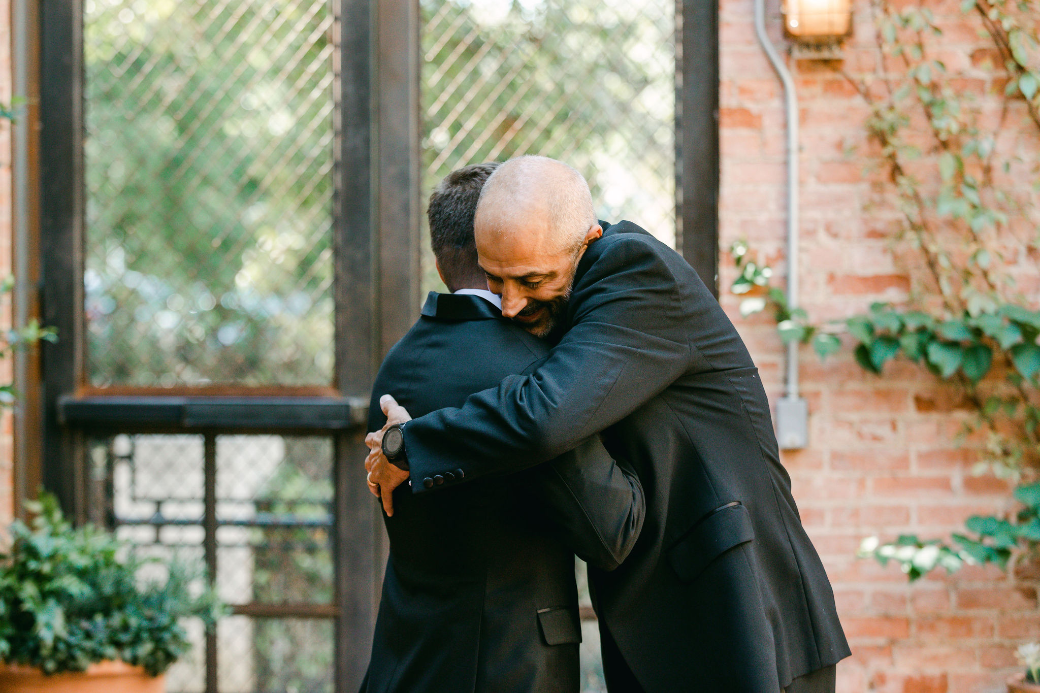 dad-groom-embrace-before-ceremony-hotel-emma