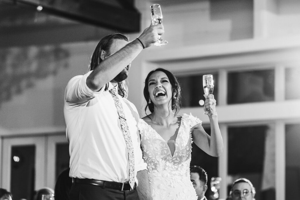bride-and-groom-cheers-at-reception-austin-wedding-photographer