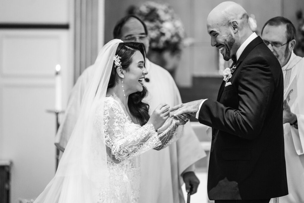 Bride-groom-laugh-during-ring-exchange-Austin-church-wedding