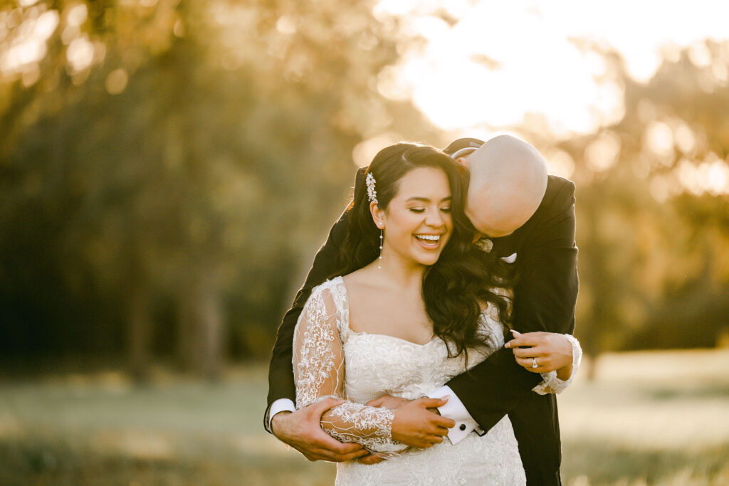 Groom-hugs-bride-after-ceremony-under-sunset-Austin