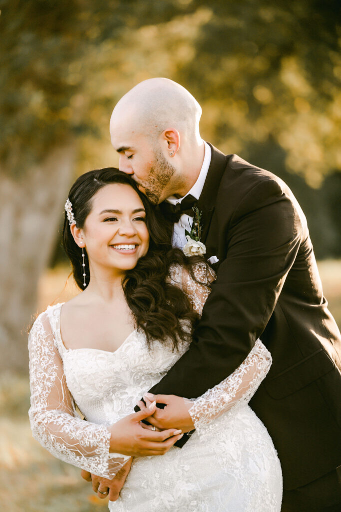 Bride-groom-cuddle-outside-texas-hill-country-weddings