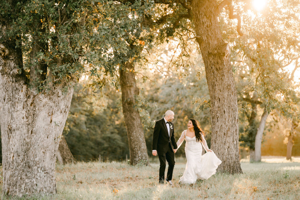 Couple-running-down-hill-sunset-wedding-Dripping-Springs