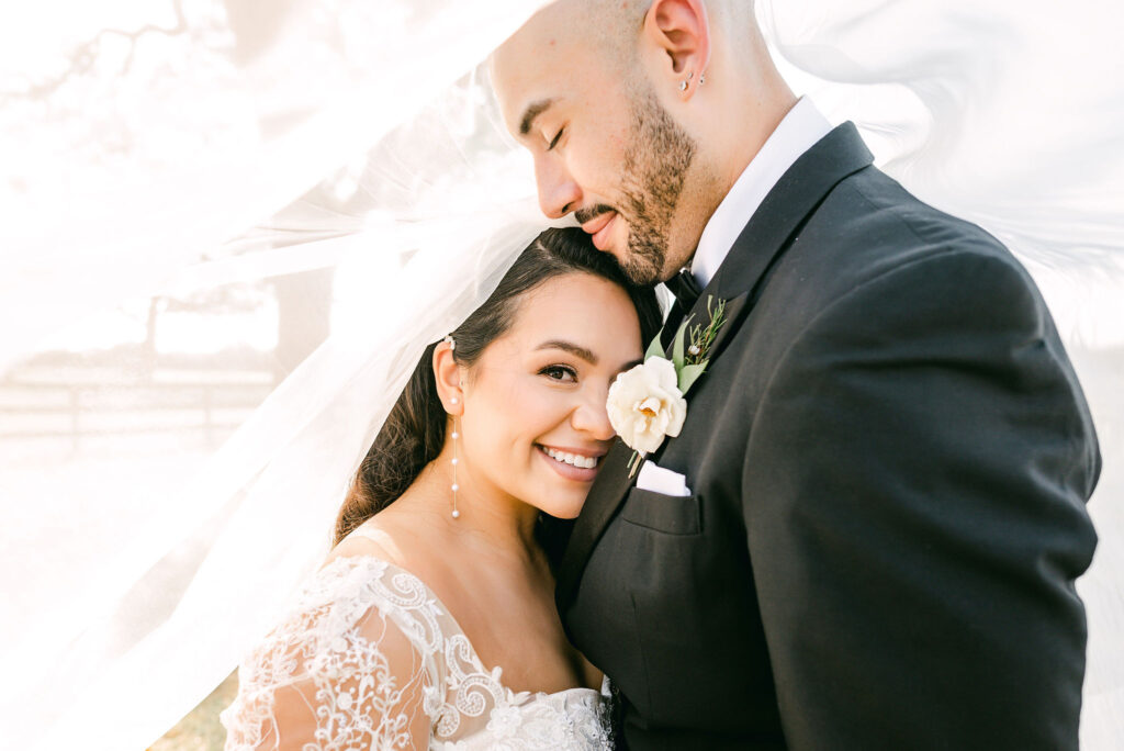 Bride-smiles-under-veil-Dripping-Springs-wedding-photographer