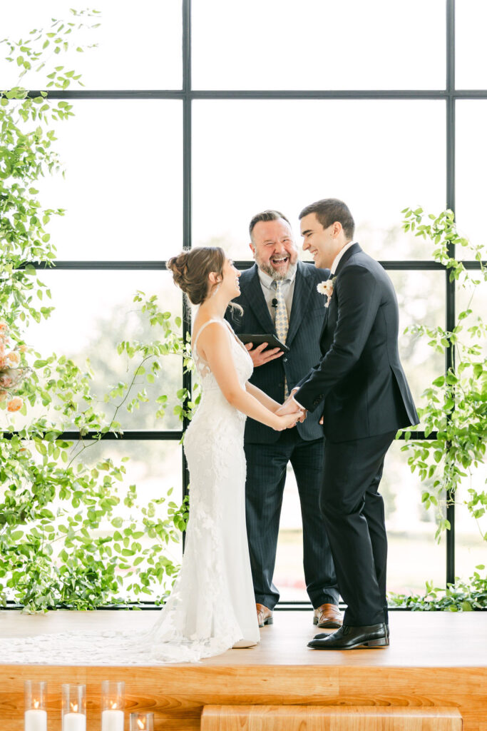 Bride-groom-laugh-with-officiant-chapel-ceremony-austin-weddings