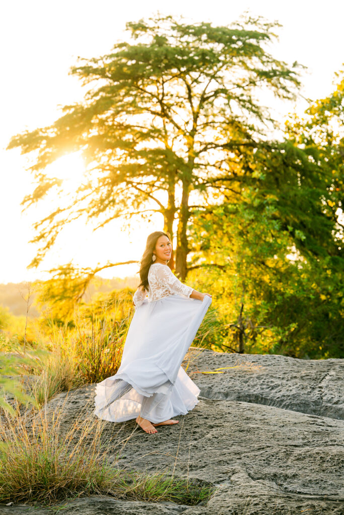 pregnant-mom-swings-dress-around-golden-hour-austin-maternity-photography