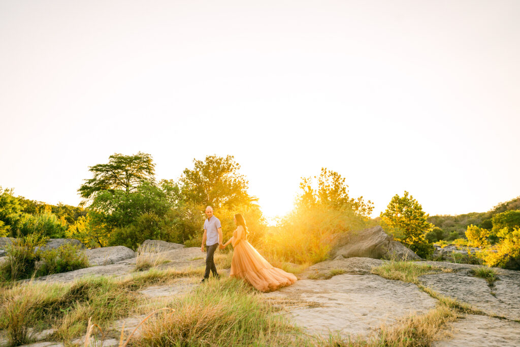 couple-walking-through-austin-park-maternity-photos