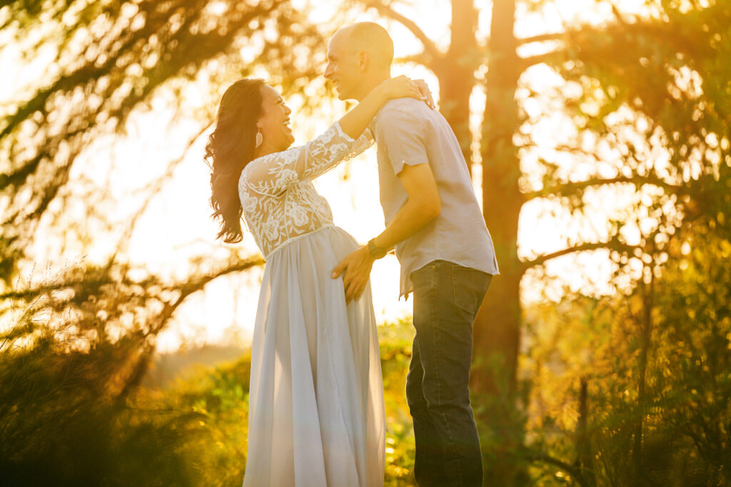 couple-laughing-sunset-light-maternity-photography-austin