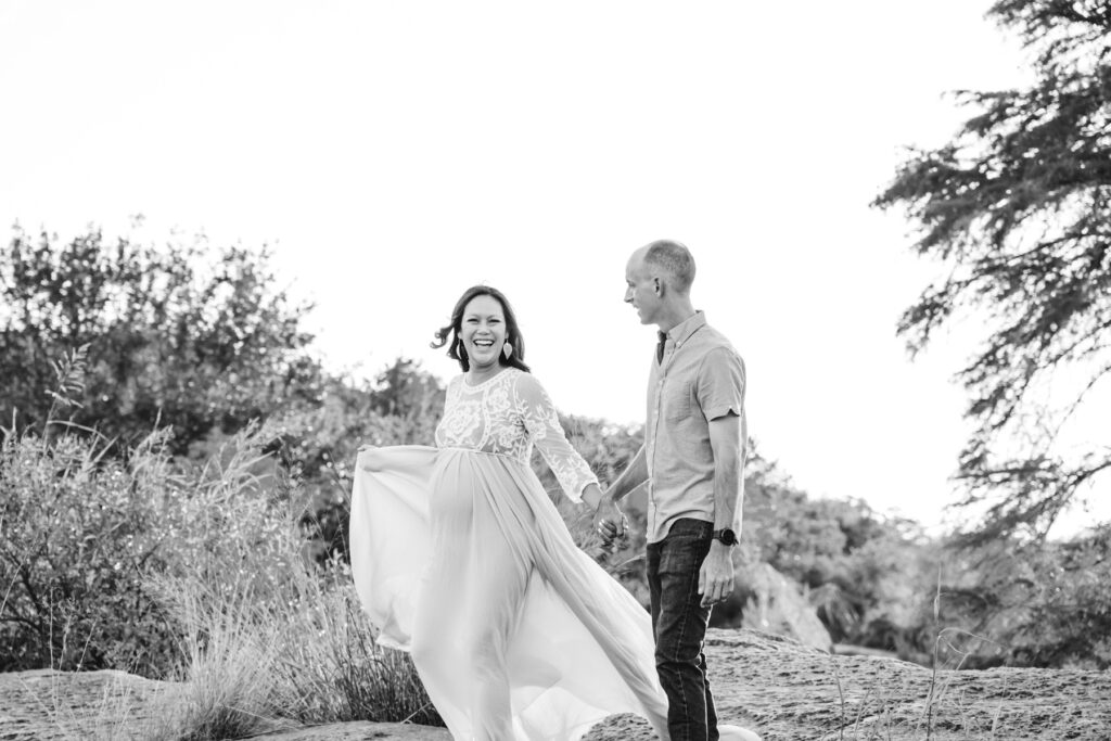 pregnant-mother-laughs-with-husband-dripping-springs-maternity-photos