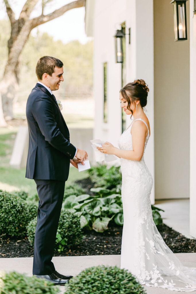 couple reading private vows during first look 