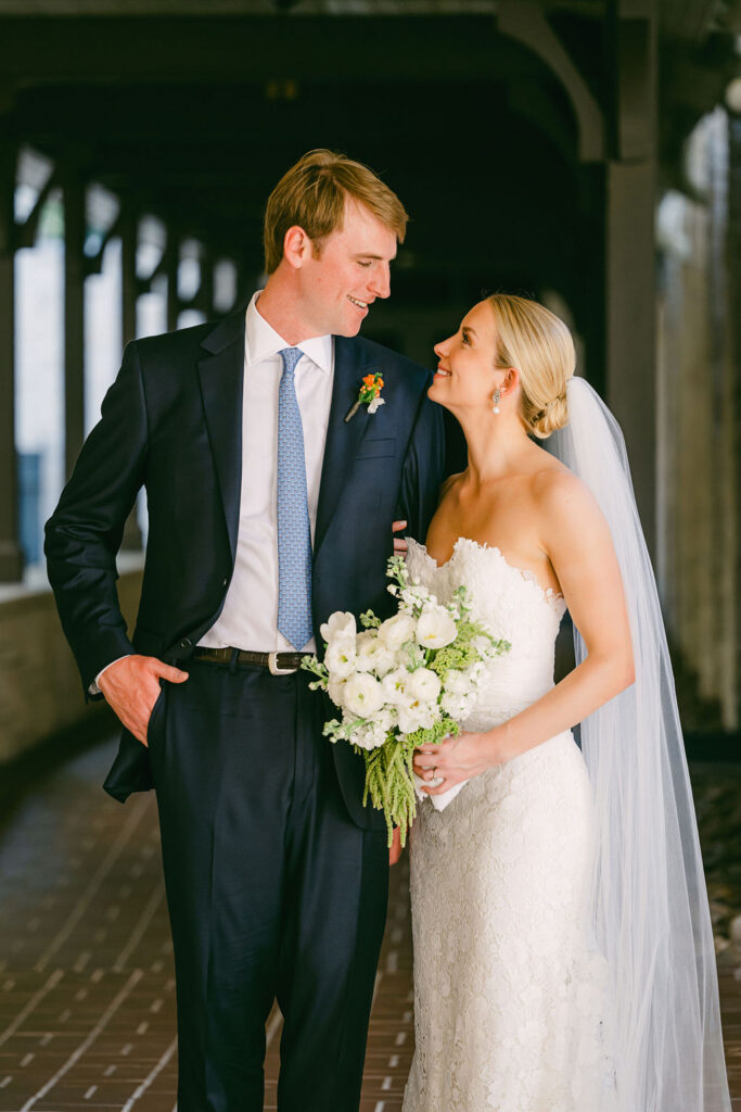 bride and groom looking at each other during wedding portraits