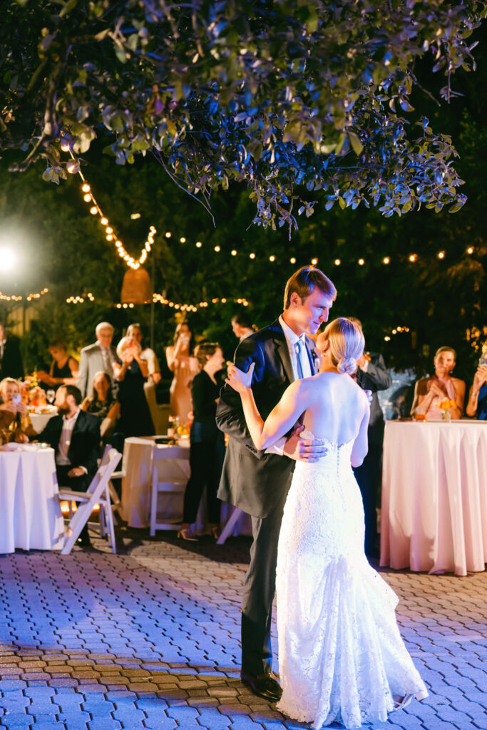 couple perform first dance during reception at allan house under twinkling lights