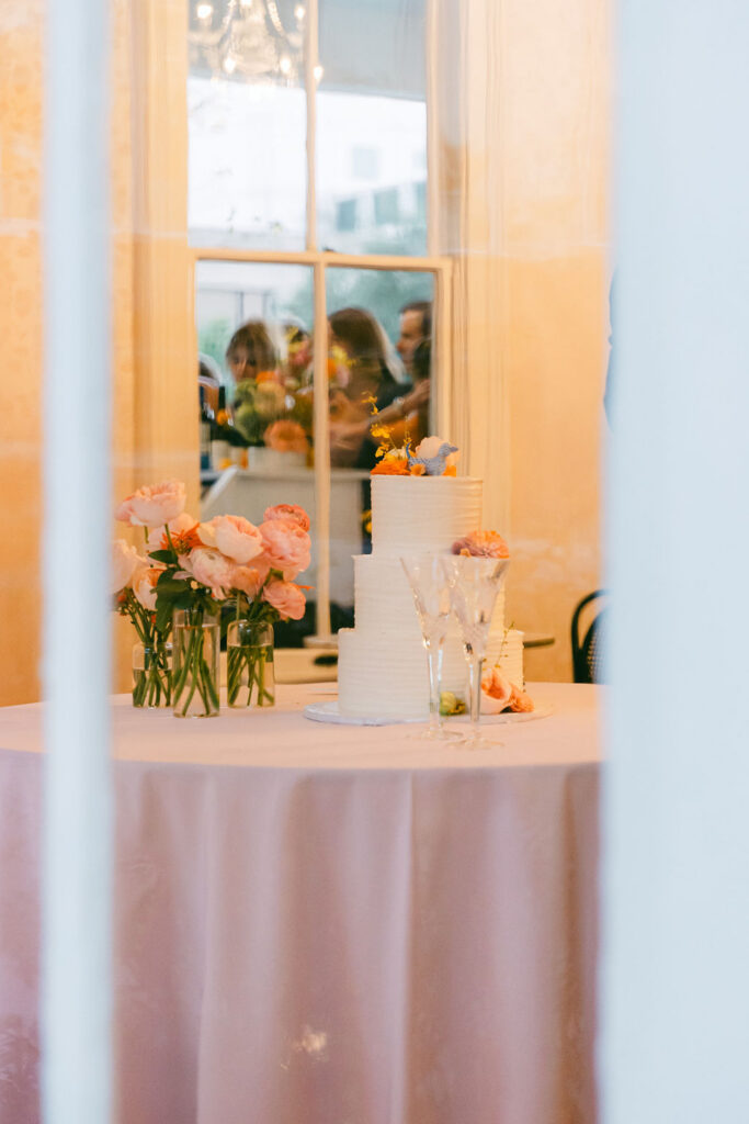 photo of the cake and florals through the window