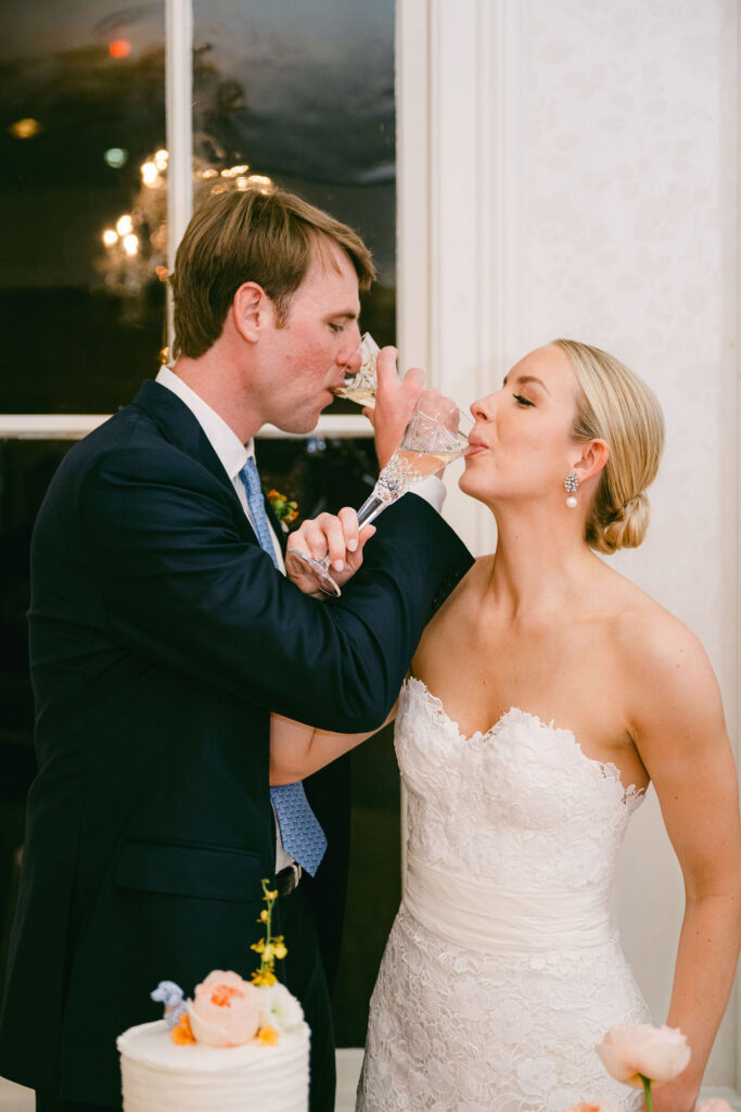 couple link arms and drink champagne