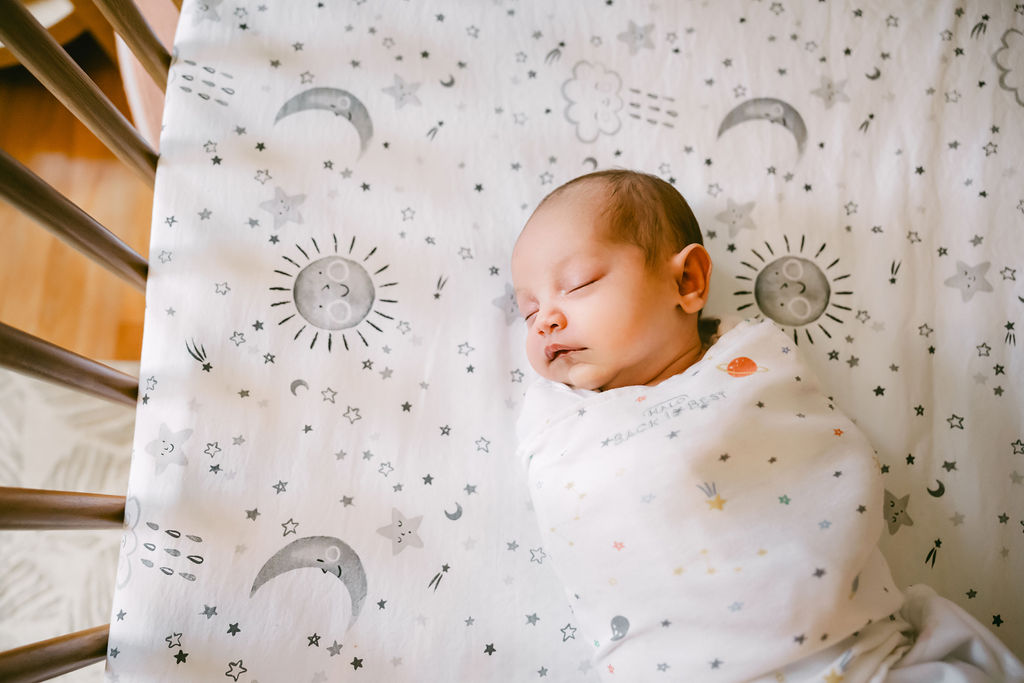 A sweet Austin newborn girl sleeping in the crib