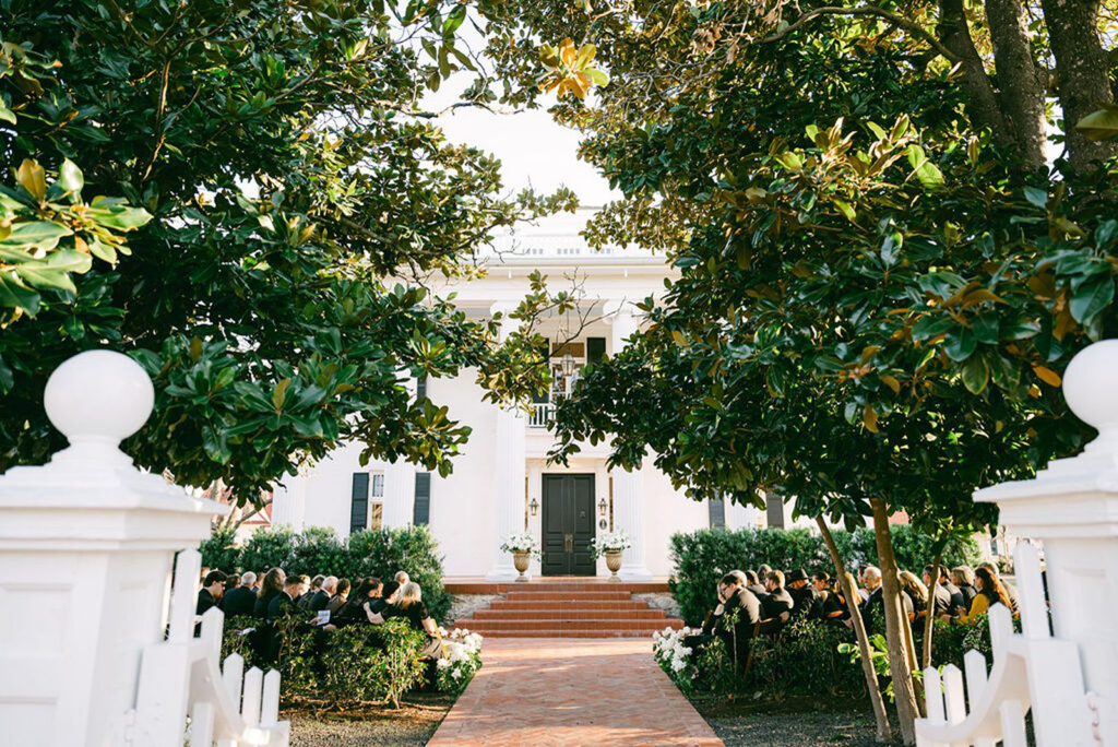 Elegant and classic Woodbine Mansion ceremony outdoors in front of house in Austin