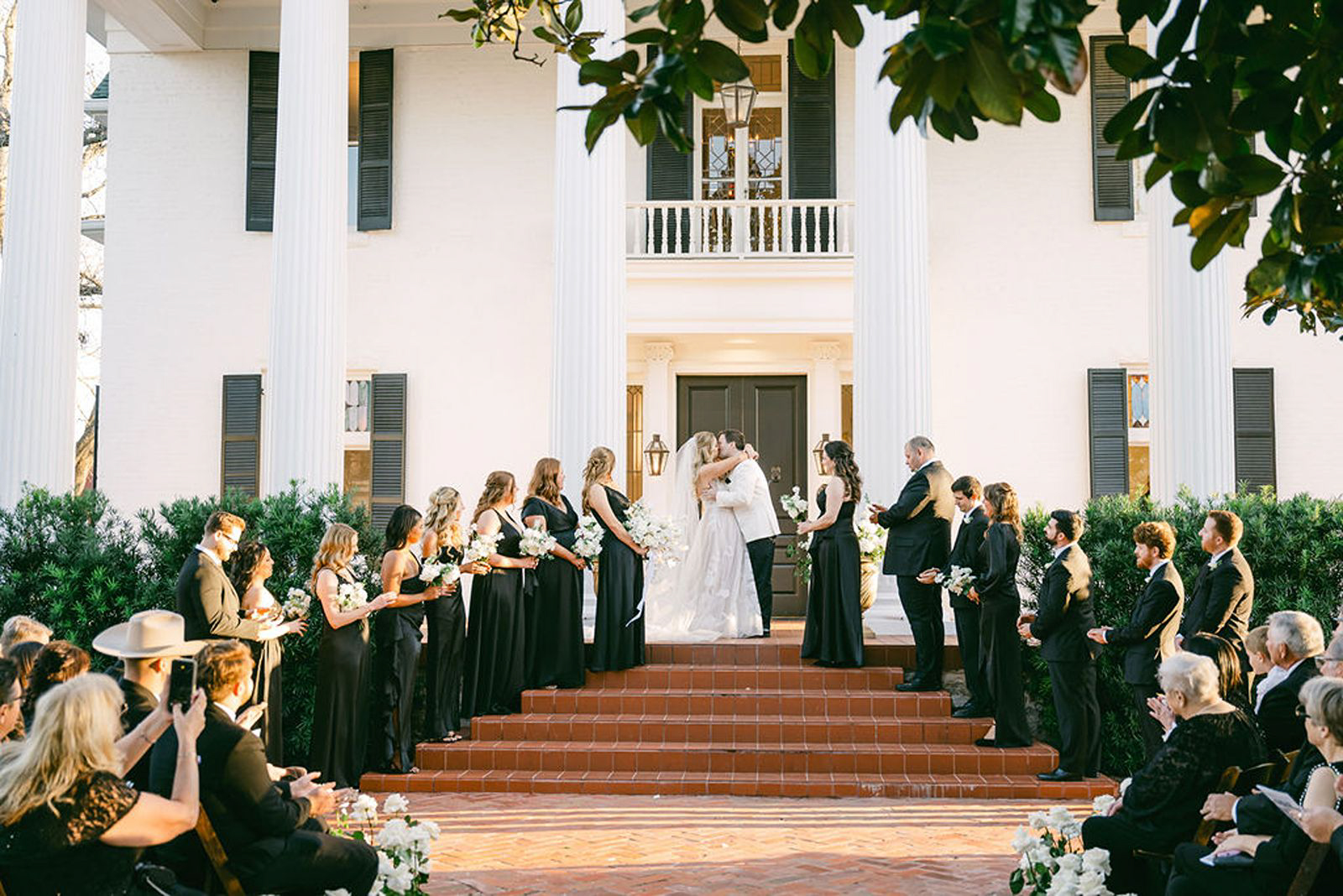 Bride and groom kiss during ceremony at the Woodbine Mansion in Round Rock, Austin Texas