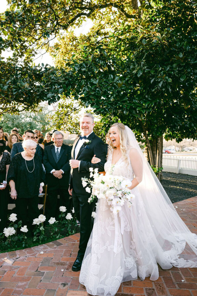 Bride walks down aisle at Woodbine Mansion in Austin on a fall day