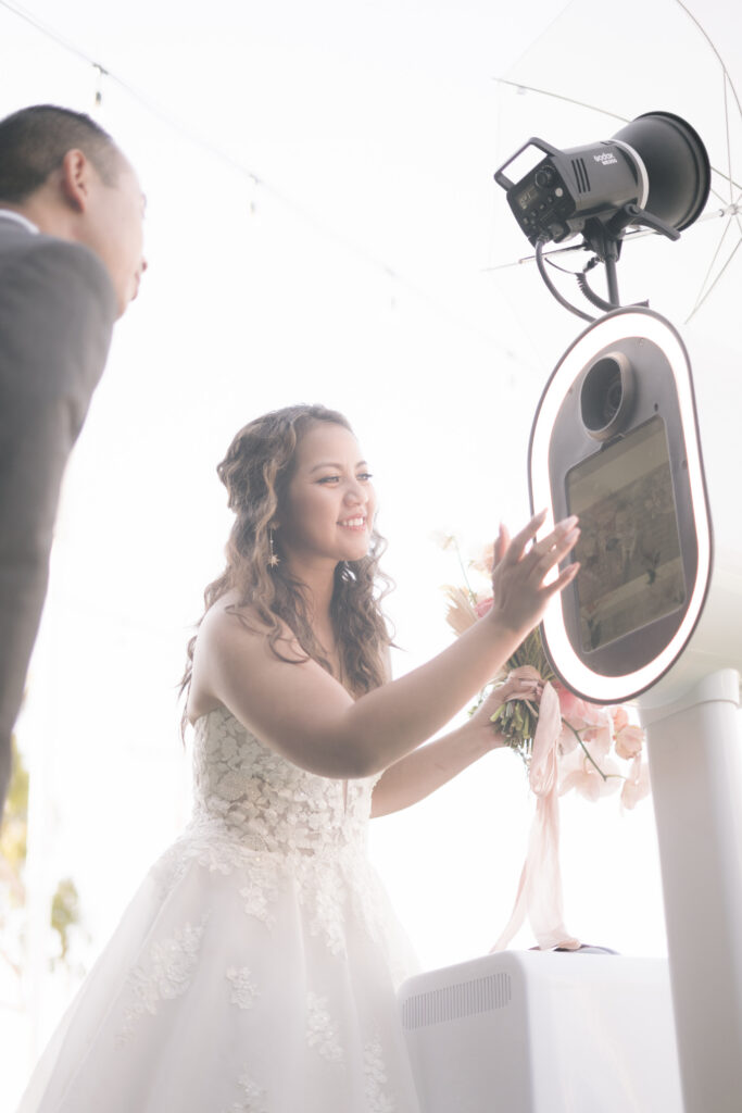 couple using the touchscreen of the photo booth