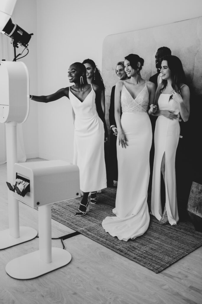 couple and guests take photos with the Austin photo booth rental
