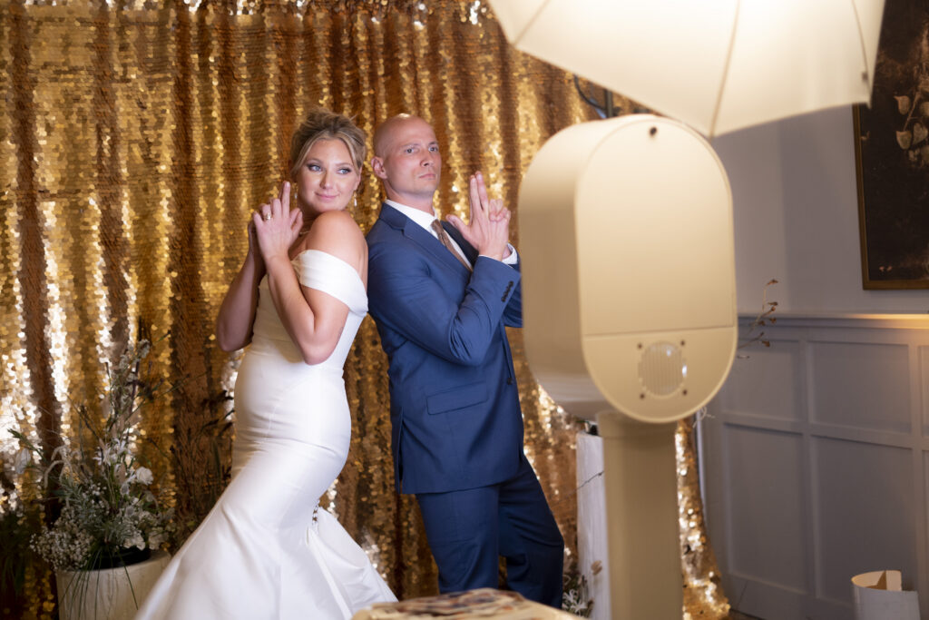 couple pose in front of photo booth