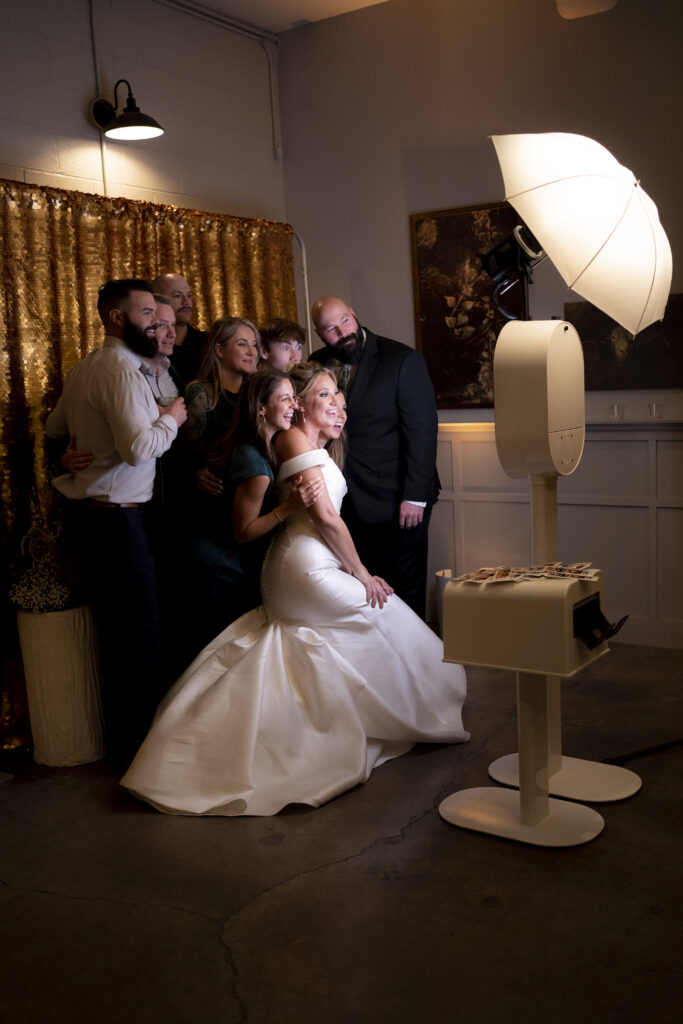 couple and guests take photos with the Austin photo booth rental