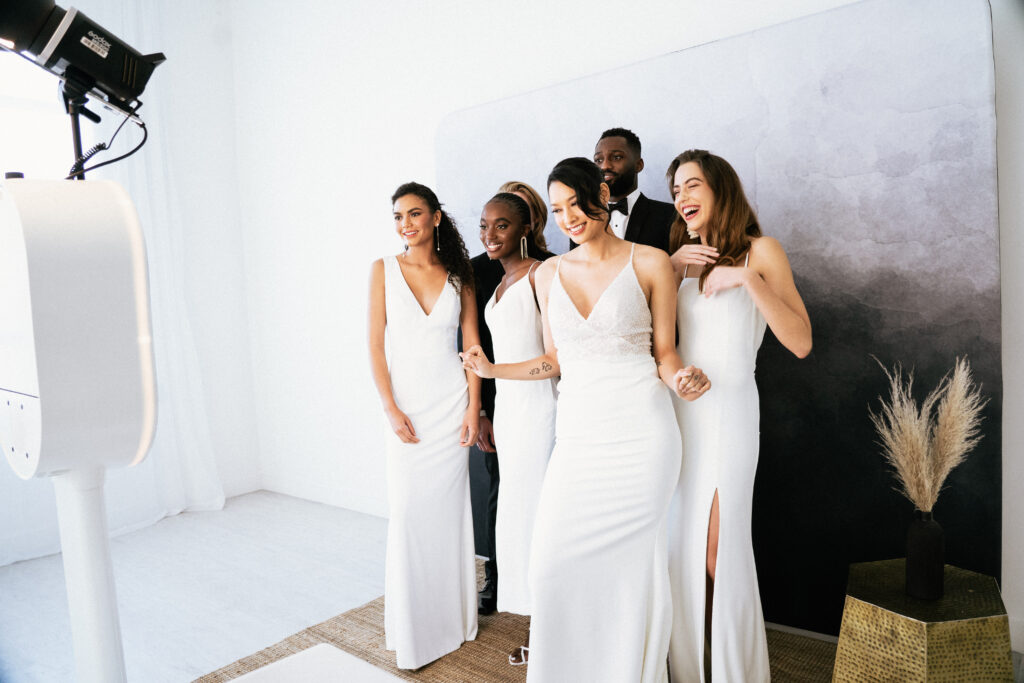 couple and guests take photos with the photo booth rental