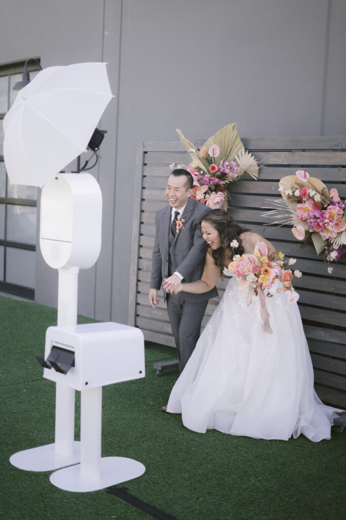 couple laughing when taking photos with the photobooth